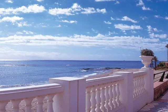 Vue sur la mer depuis une promenade en bord de mer ensoleillée.