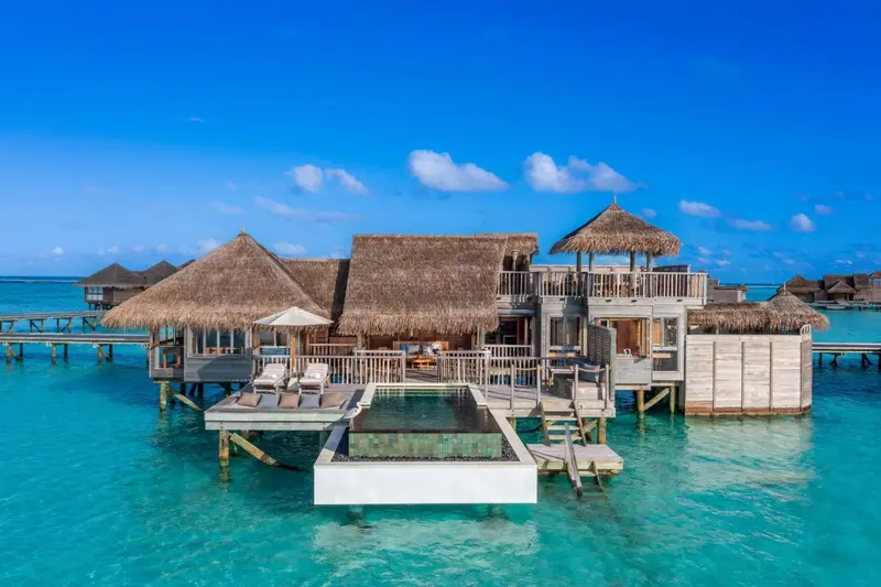 Vues aériennes de bungalows sur pilotis avec piscine privée et terrasse.