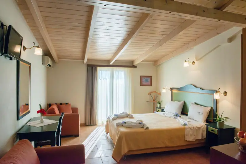 Une chambre lumineuse avec un lit et un coin salon.