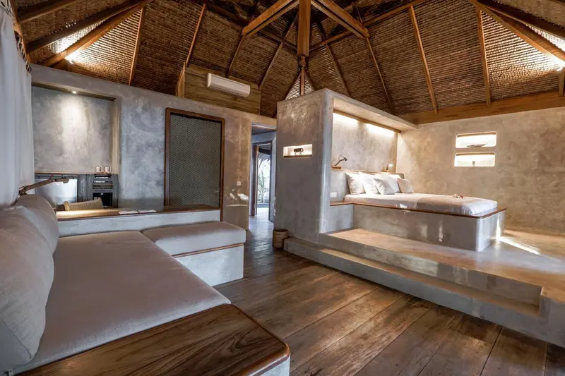 Espace de vie intérieur lumineux avec un canapé et un lit surélevé.