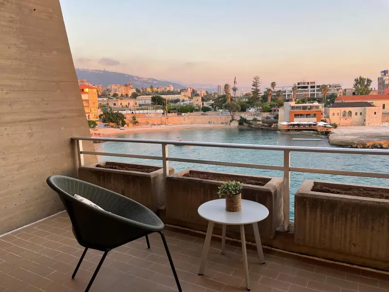 Terrasse avec mobilier d'extérieur donnant sur une vue côtière.