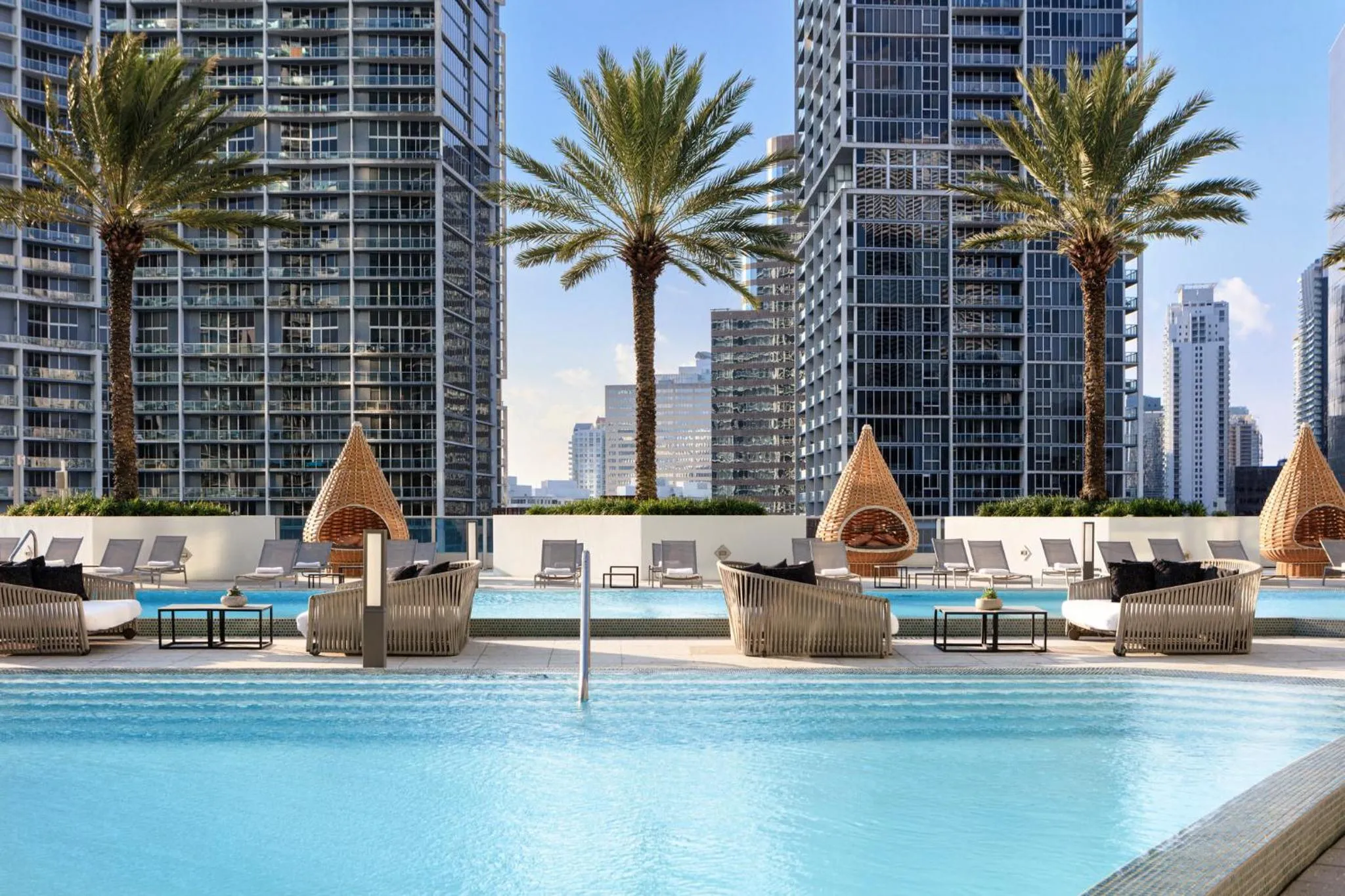 Terrasse avec piscine et mobilier de détente.