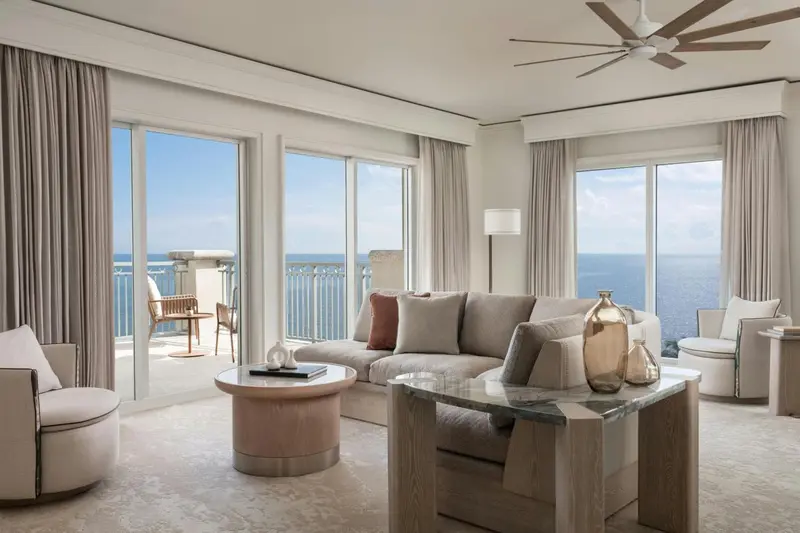 Un salon lumineux s'ouvre sur une terrasse avec vue sur la mer.