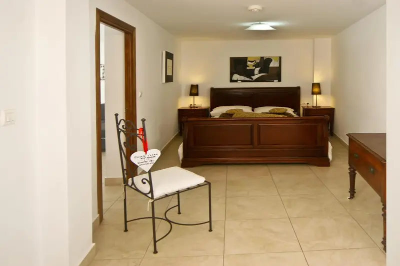 Une chambre lumineuse avec un grand lit et une décoration murale.
