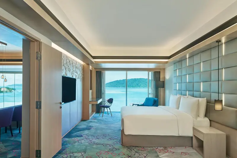 Chambre moderne avec un grand lit et une vue sur la mer.