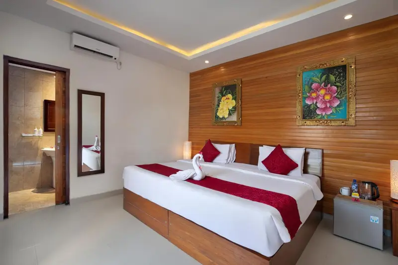 Chambre lumineuse avec un grand lit et une décoration florale.