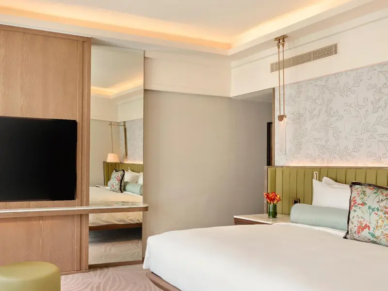 Une chambre lumineuse avec un grand lit et une décoration sobre.