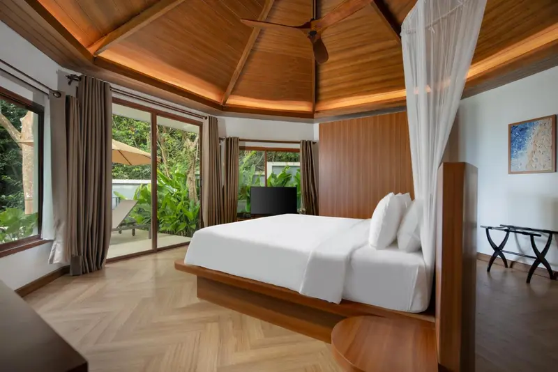 Une chambre lumineuse avec un grand lit et un accès à une terrasse.