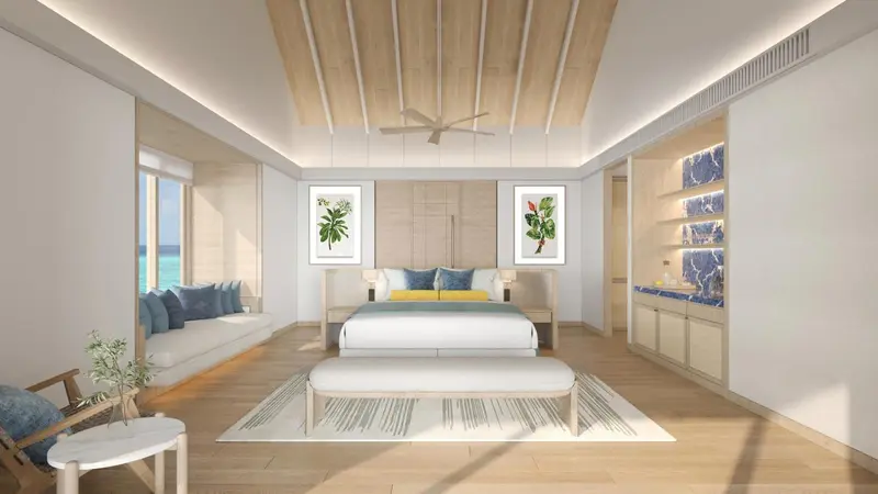 Une chambre lumineuse avec un grand lit et un coin salon donnant sur l'océan.
