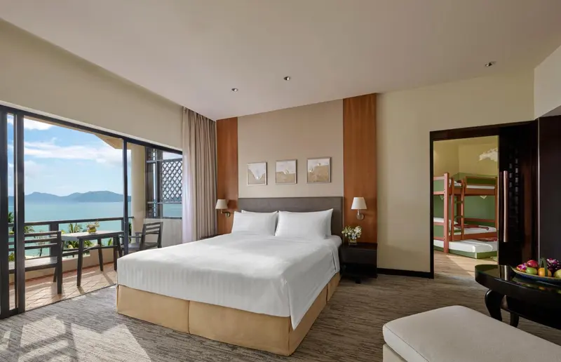 Une chambre lumineuse avec un grand lit et une vue sur la mer.