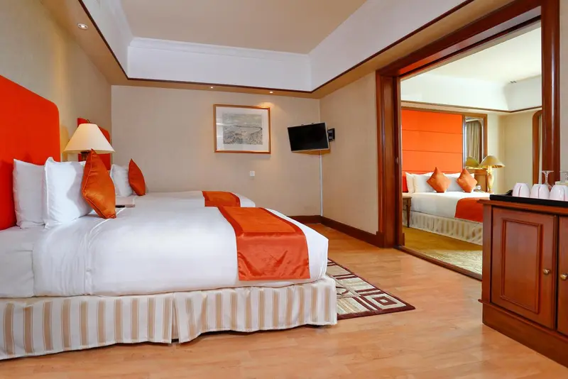 Une chambre lumineuse avec un grand lit et un miroir.