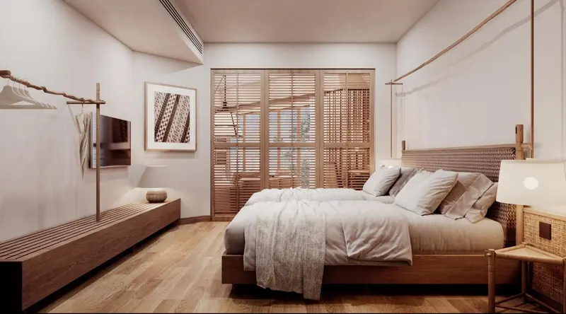Une chambre lumineuse avec un grand lit et des persiennes en bois.