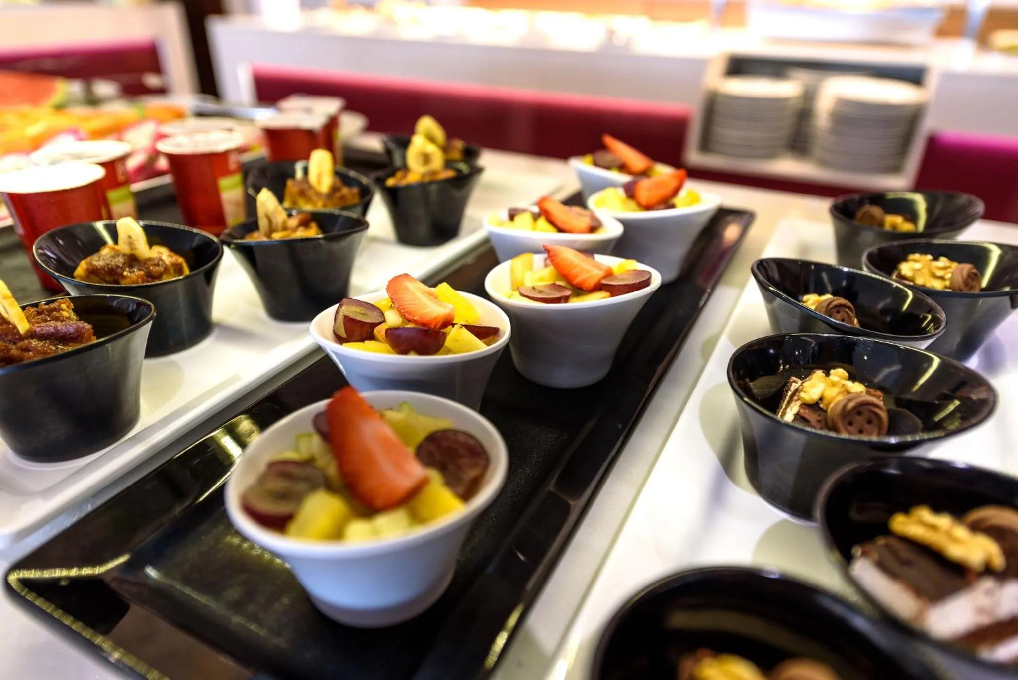 Présentation de petites portions de desserts variés sur un buffet.