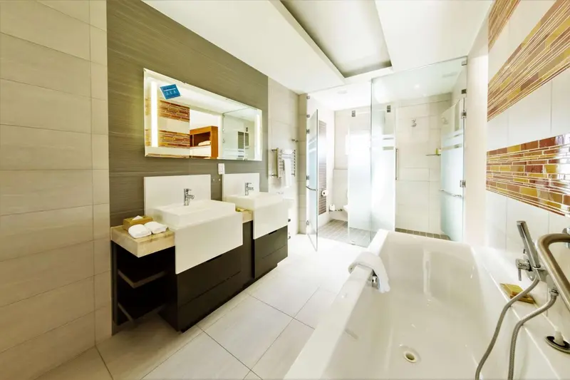 Une salle de bain moderne avec deux vasques et une baignoire.