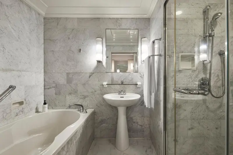 Une salle de bain lumineuse avec baignoire et douche à l'italienne.