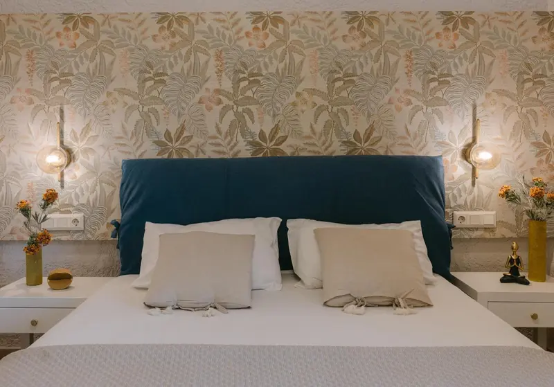Une chambre à coucher avec un grand lit recouvert d'une courtepointe et de coussins.