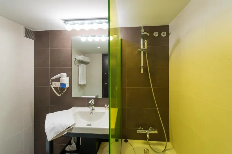 Une salle de bain moderne avec douche et lavabo.
