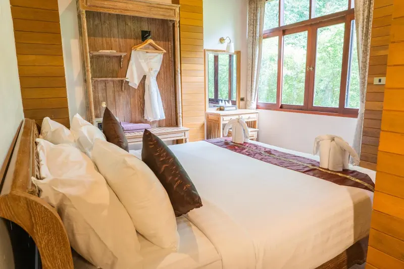 Une chambre lumineuse avec un grand lit et une décoration en bois.