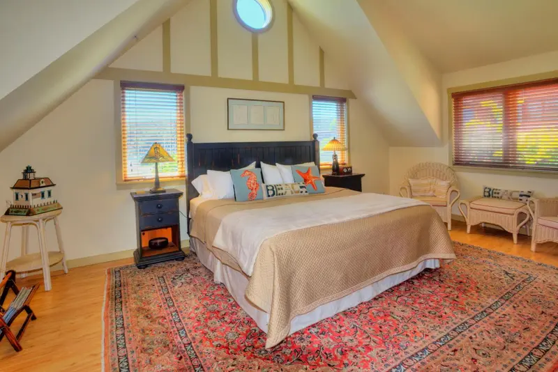 Une chambre lumineuse avec un grand lit et une décoration maritime.