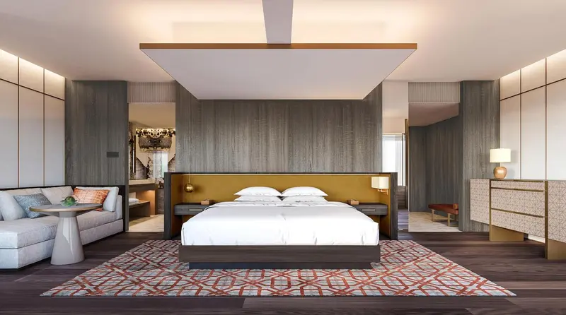 Une chambre spacieuse avec un grand lit et un coin salon.