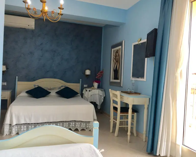 Une chambre lumineuse avec un lit à baldaquin et un coin repas.
