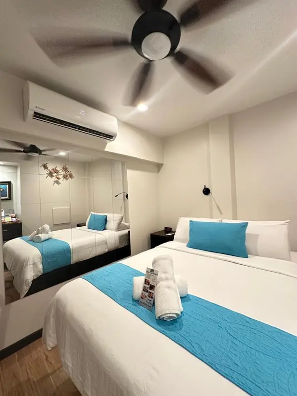 Une chambre avec deux lits simples et une décoration murale.