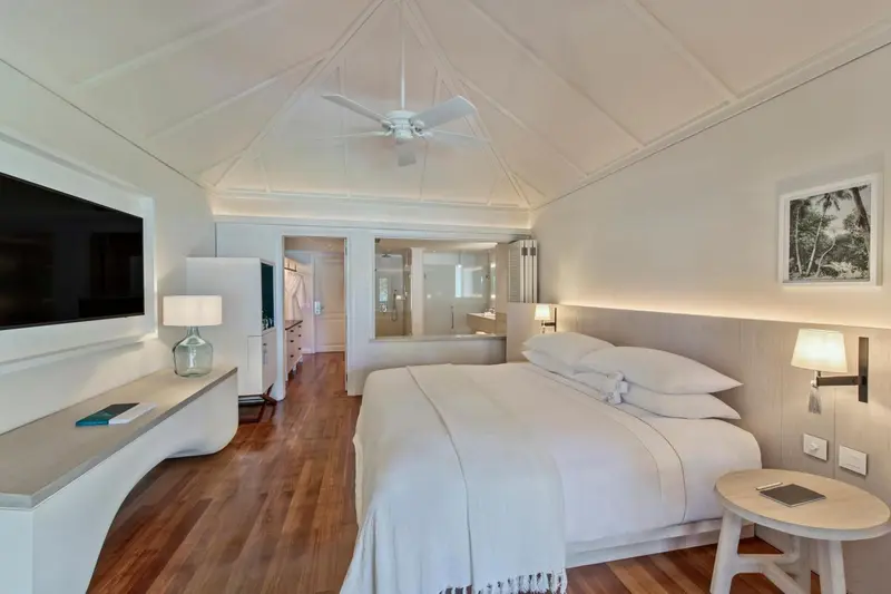 Une chambre lumineuse avec un grand lit et un espace détente.