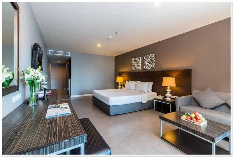 Une chambre d'hôtel moderne avec un lit double et un coin salon.