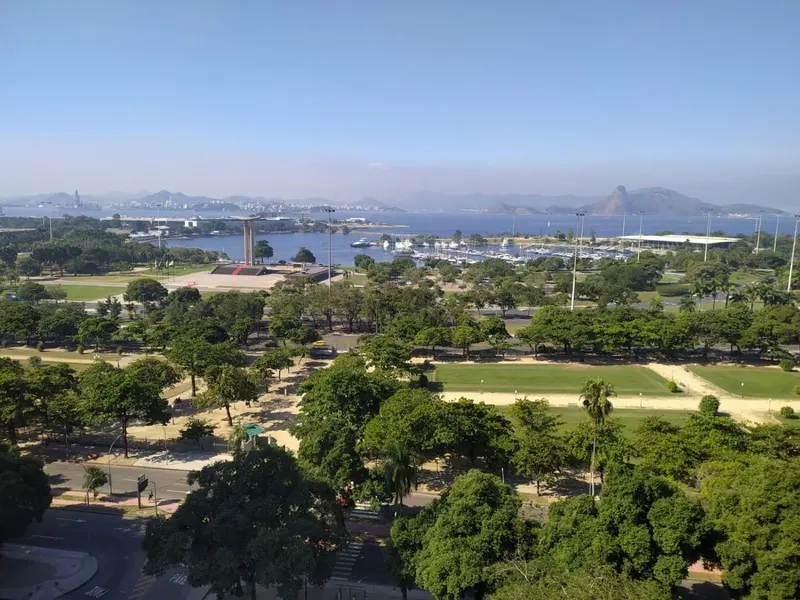Vue aérienne d'une ville côtière avec des espaces verts et une marina.