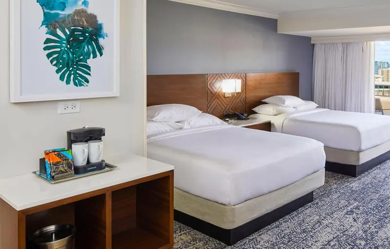 Une chambre d'hôtel avec deux lits et une machine à café.