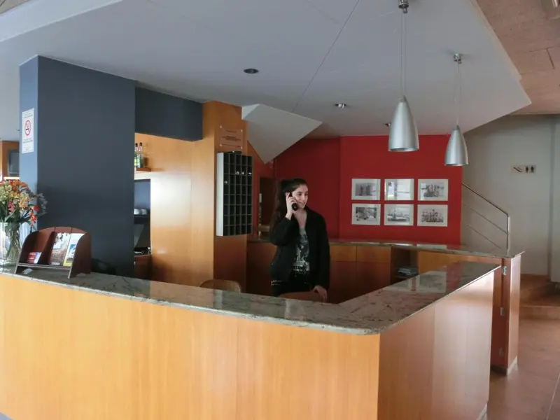 Une réception d'hôtel avec une employée au téléphone.