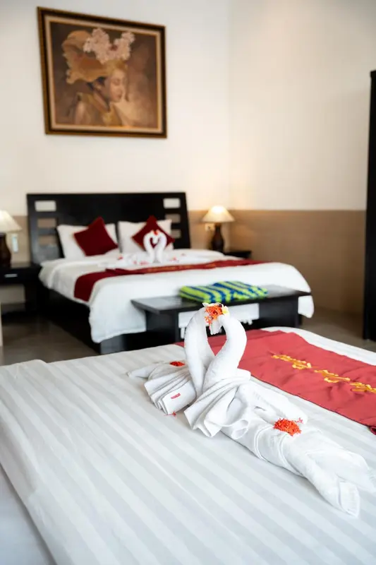 Une chambre d'hôtel avec un lit décoré de serviettes en forme de cygnes.