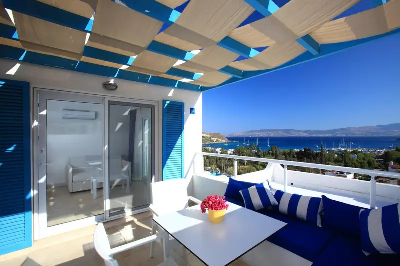 Terrasse avec mobilier d'extérieur et vue sur la mer.
