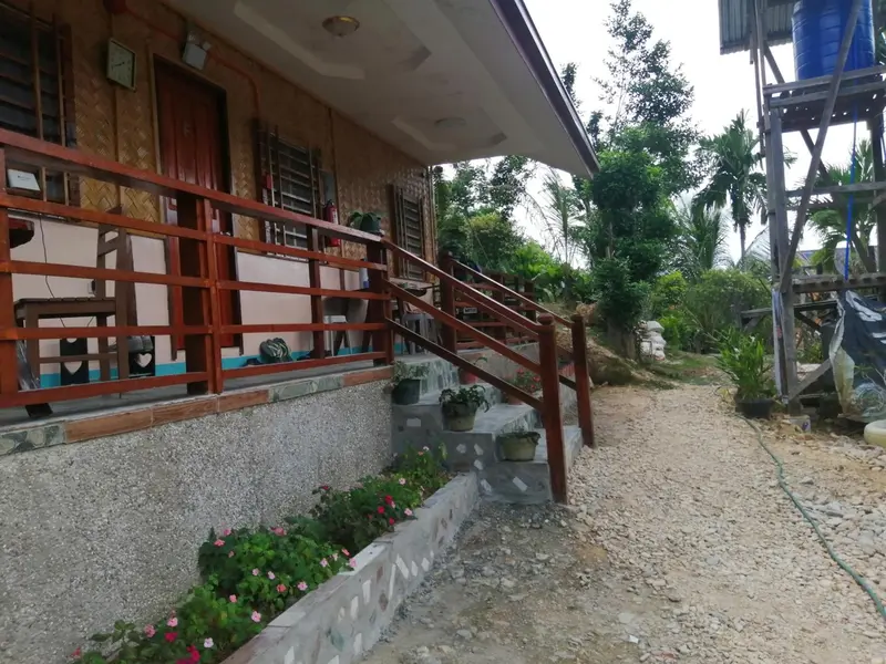Façade d'un bâtiment avec une terrasse et un escalier extérieur.
