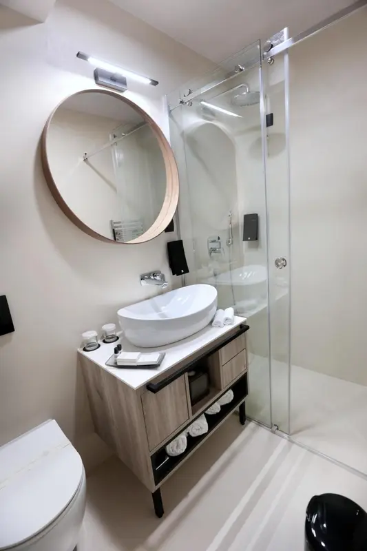 Une salle de bain moderne avec douche à l'italienne et vasque sur meuble.