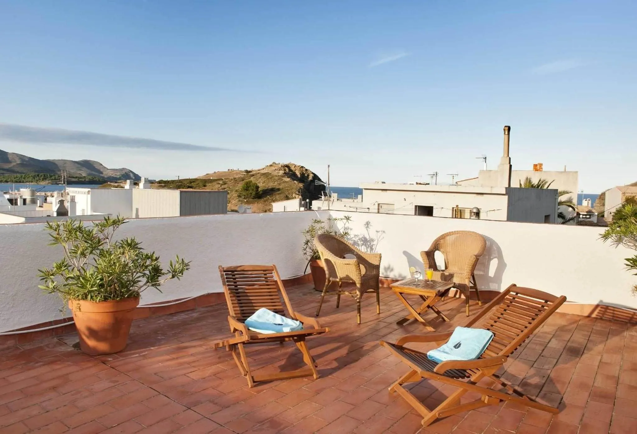 Terrasse aménagée avec chaises longues et vue sur la mer.
