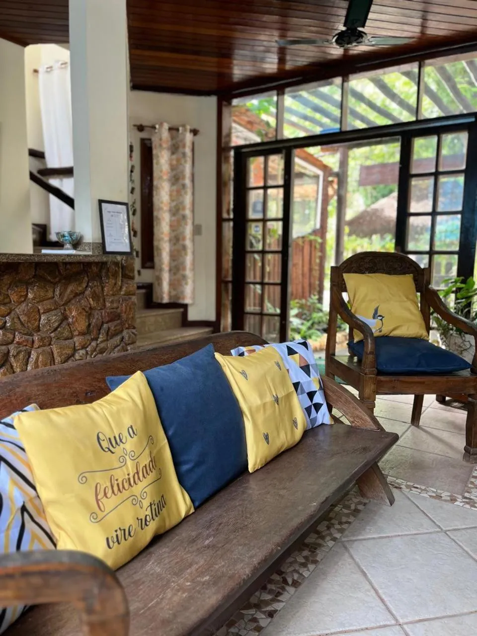 Espace de détente avec canapé et fauteuils dans un décor tropical.