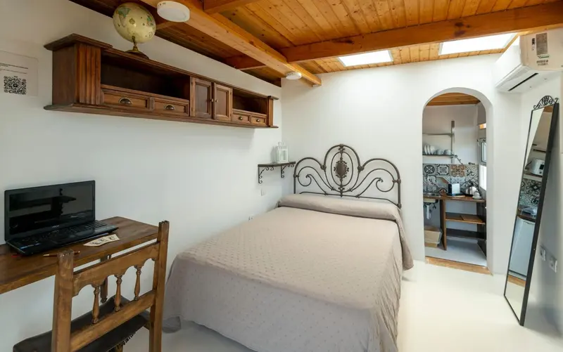 Une chambre lumineuse avec un lit et un bureau.