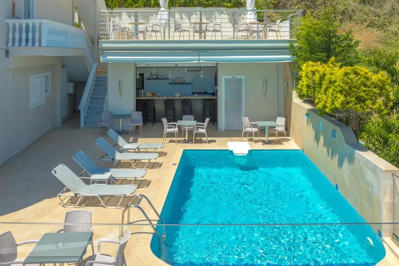 Terrasse avec piscine et bar en bord de mer.