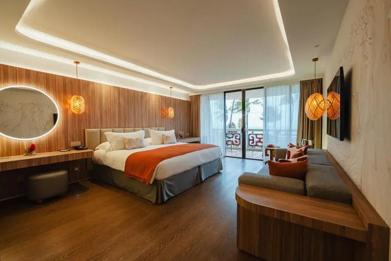 Une chambre lumineuse avec un grand lit et un espace détente.