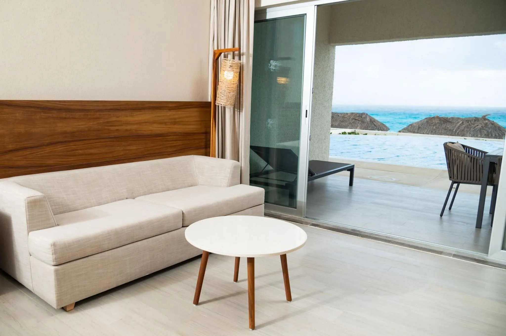Un salon clair s'ouvre sur une terrasse avec vue sur la mer.
