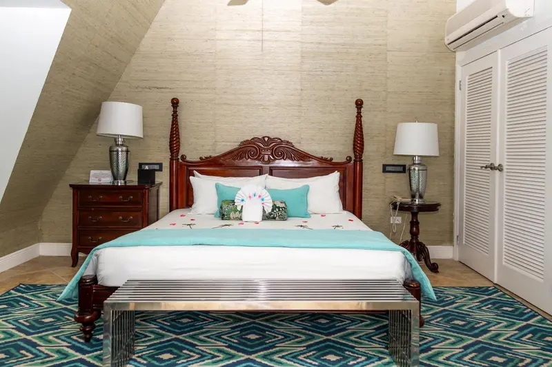 Une chambre lumineuse avec un grand lit à baldaquin et une décoration soignée.