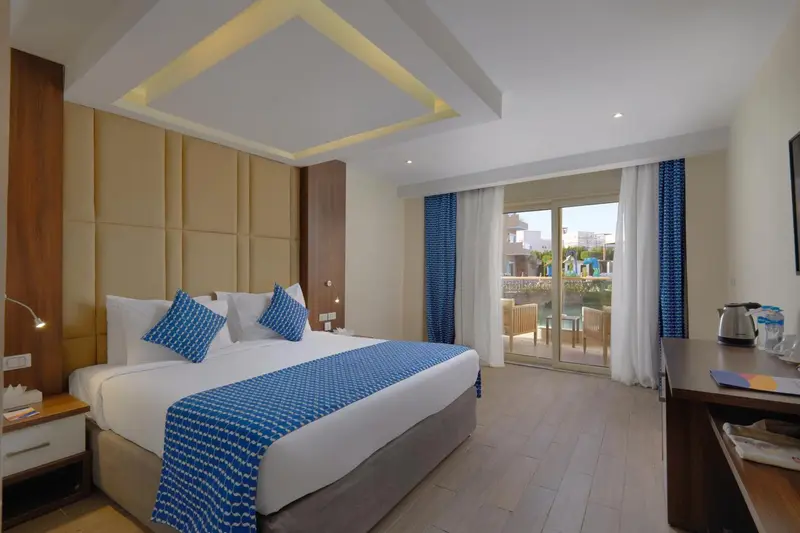 Une chambre lumineuse avec un grand lit et un accès à une terrasse.