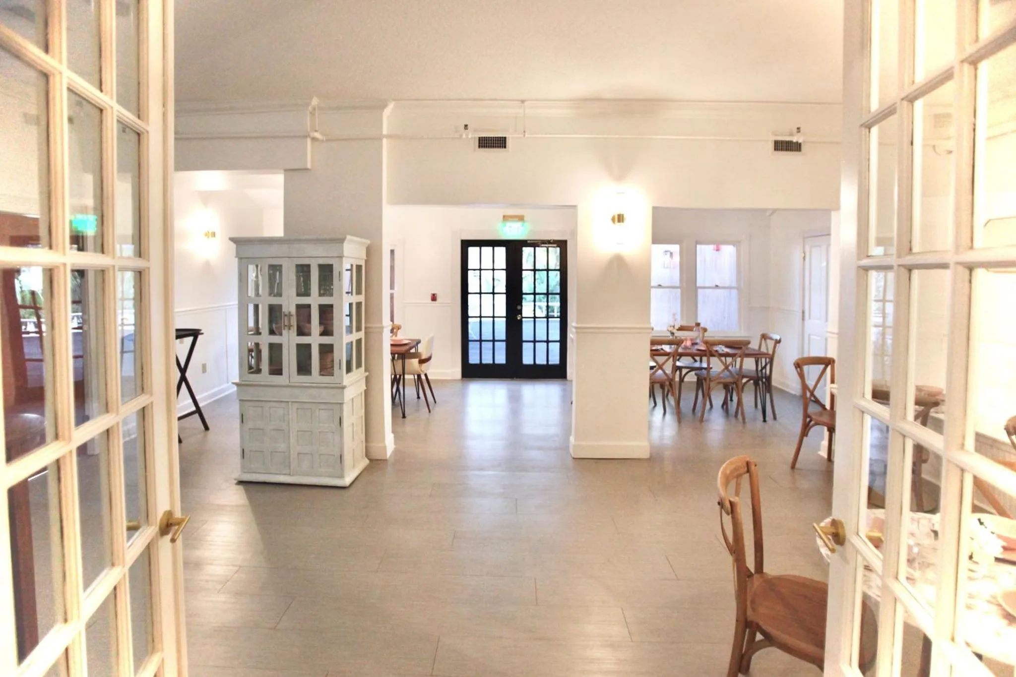 Une salle lumineuse avec des tables et des chaises.