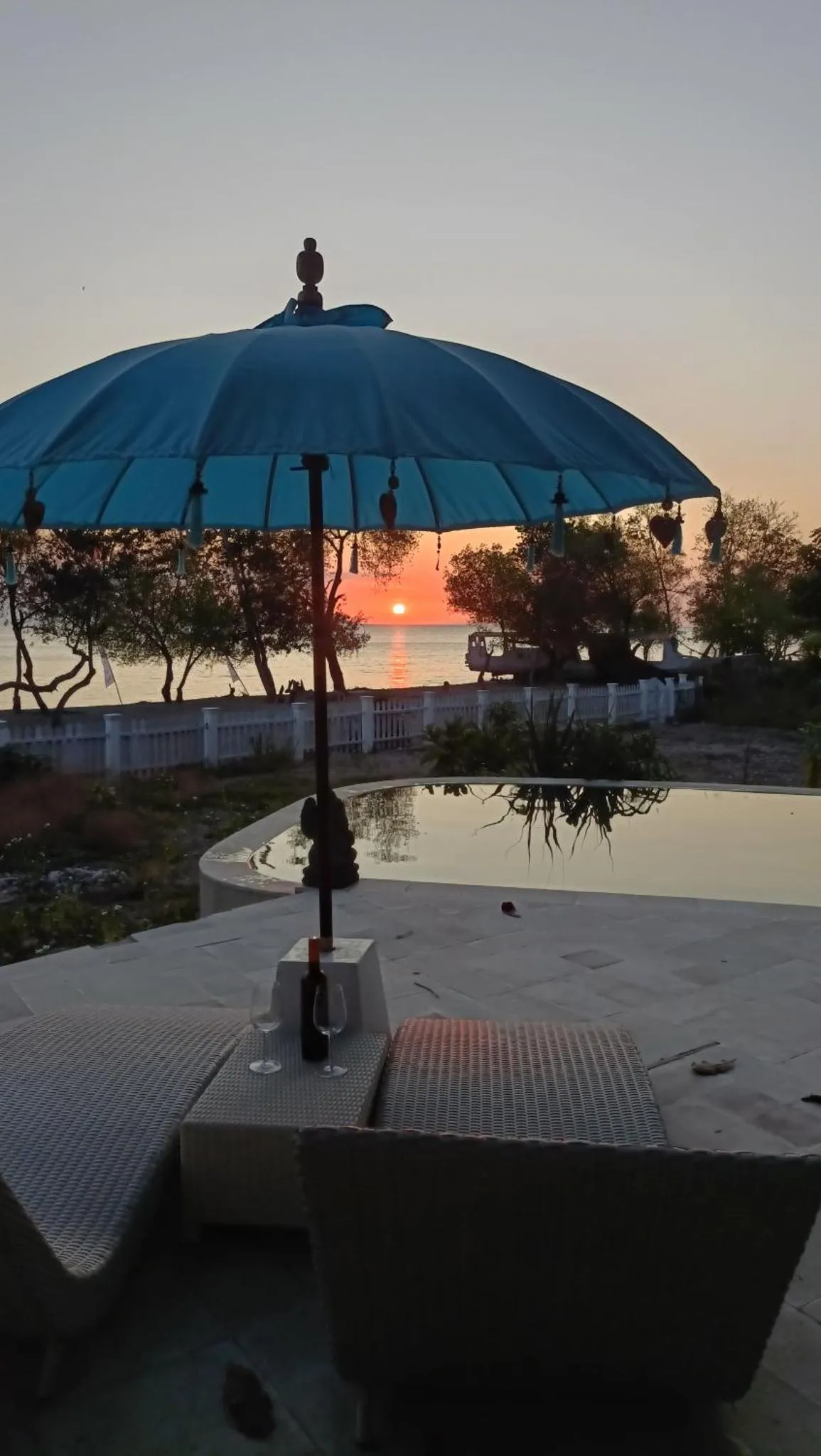 Terrasse avec piscine et vue sur le coucher de soleil.