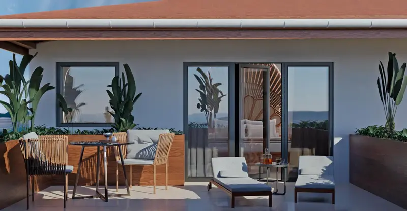 Terrasse aménagée avec salon et table basse donnant sur une vue mer.