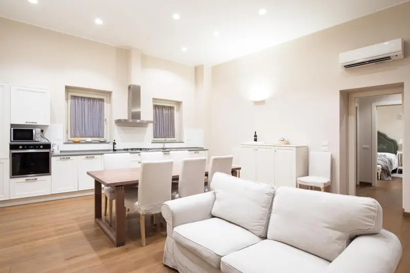 Une cuisine ouverte sur un espace repas et un coin salon.
