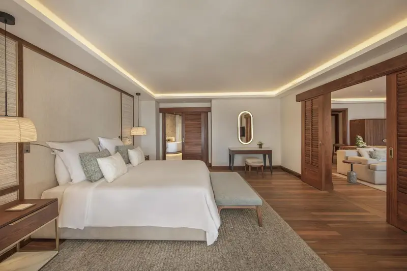 Une chambre lumineuse avec un grand lit et un espace détente.