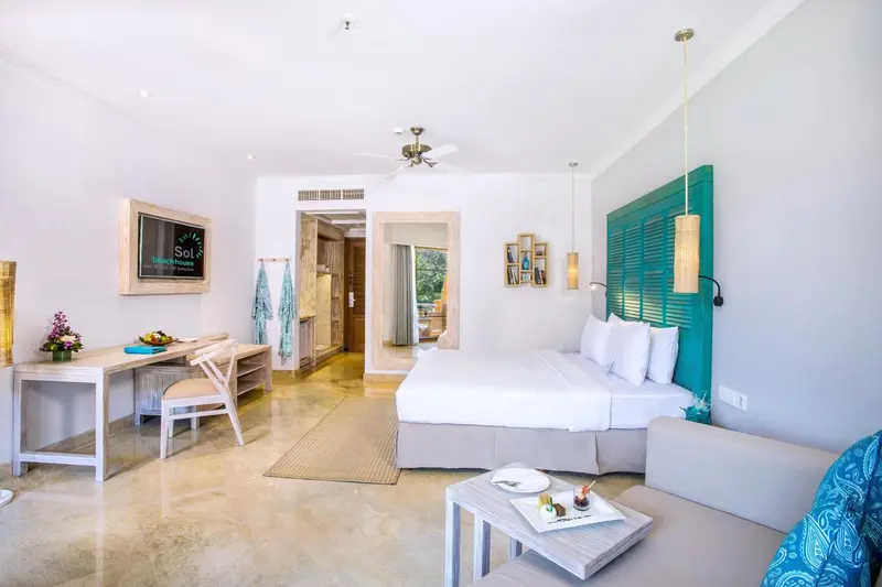 Une chambre lumineuse avec un lit king-size et un espace détente.