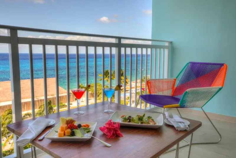 Une table de repas sur une terrasse avec vue sur la mer.